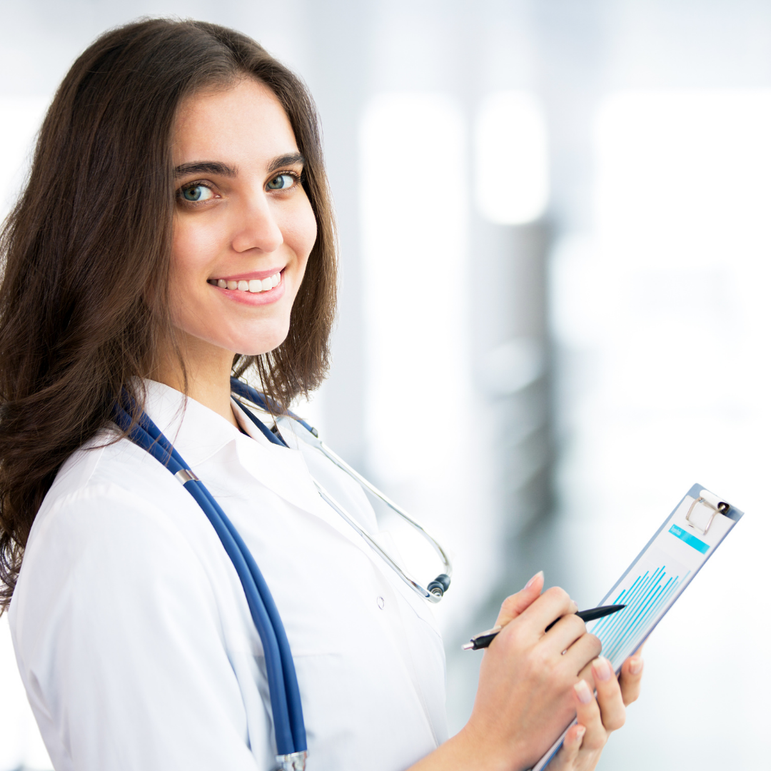a female doctor is smiling while holding a clipboard
