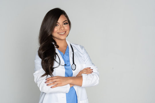 a female doctor with her arms crossed and a stethoscope around her neck