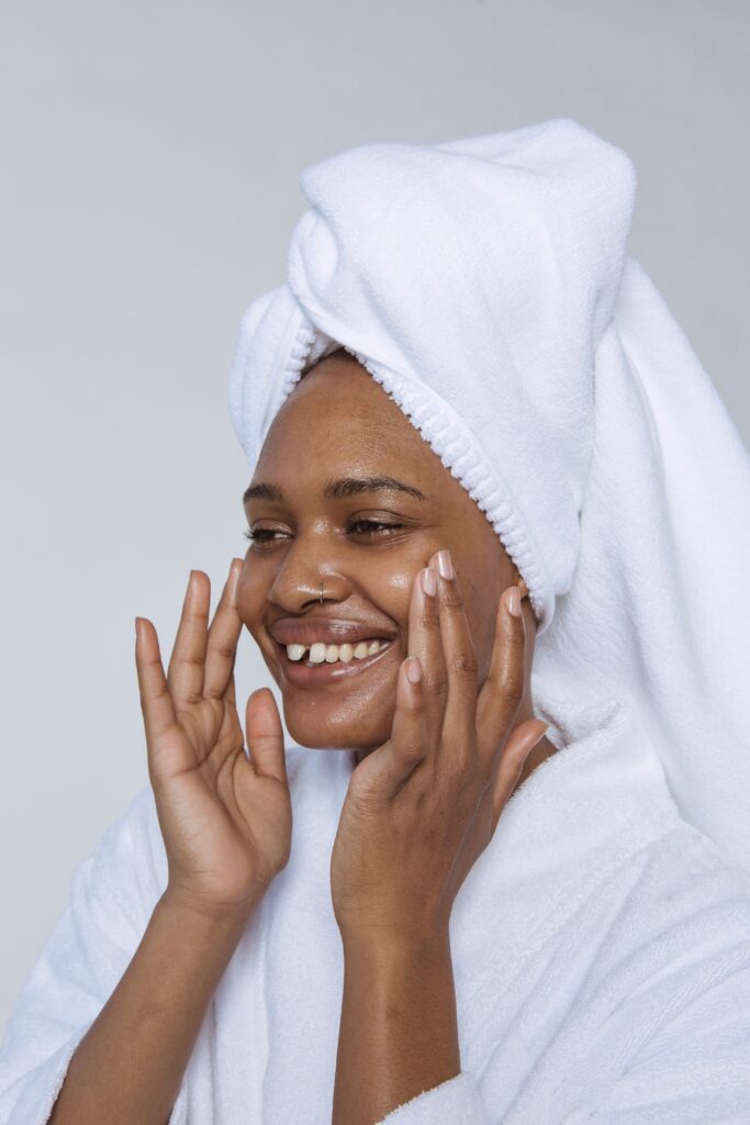 a woman with a towel wrapped around her head is smiling