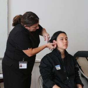 A Won Institute student performing acupuncture on another student