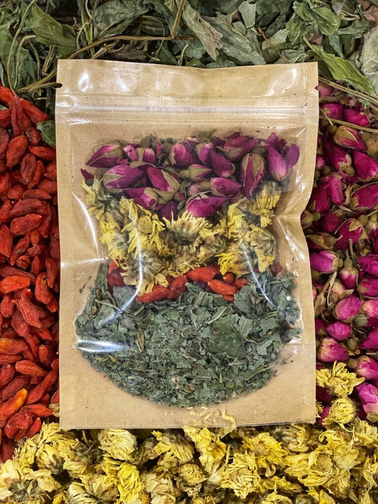 A bag of dried flowers and herbs on a table.